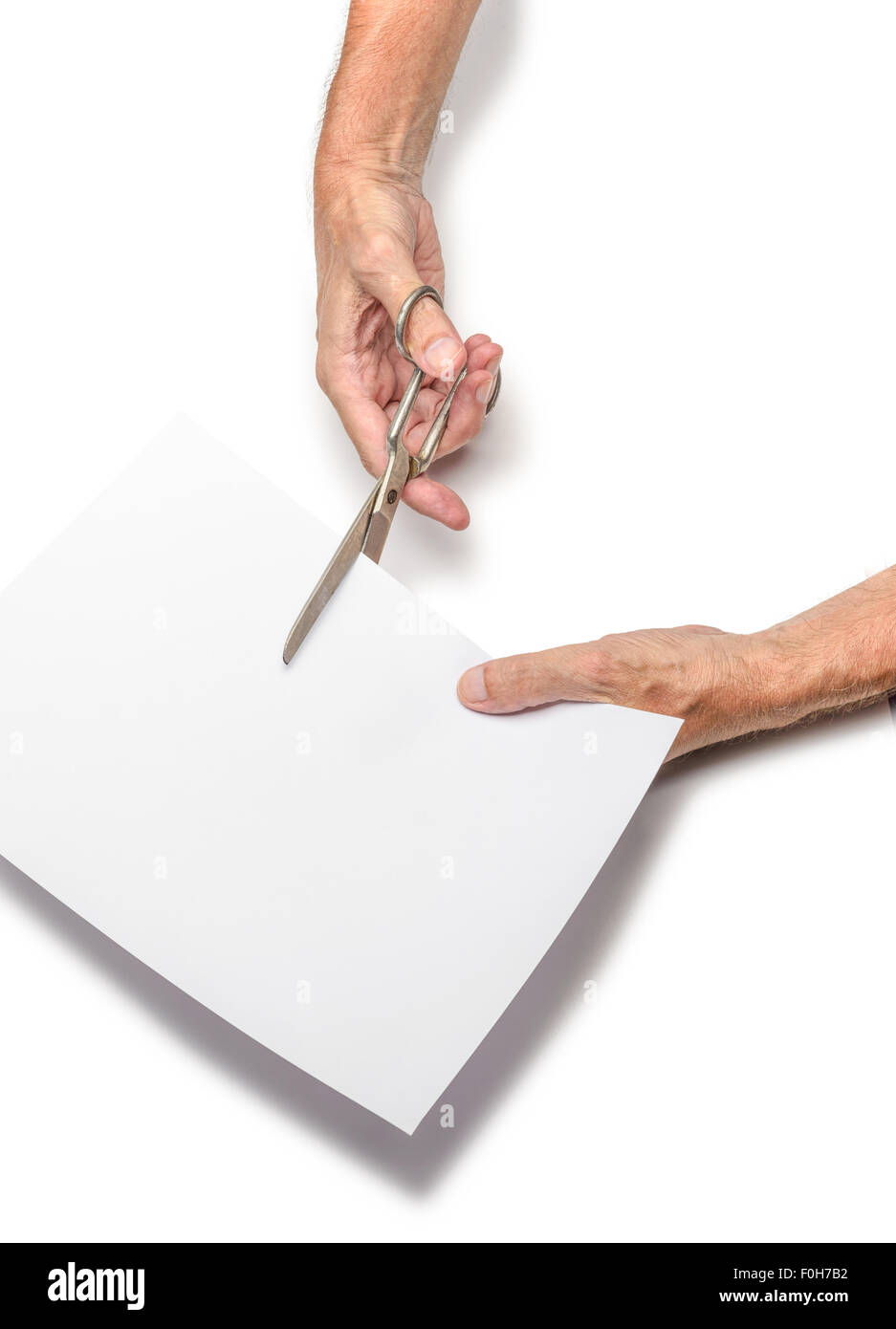 Scissors cutting paper on a desk