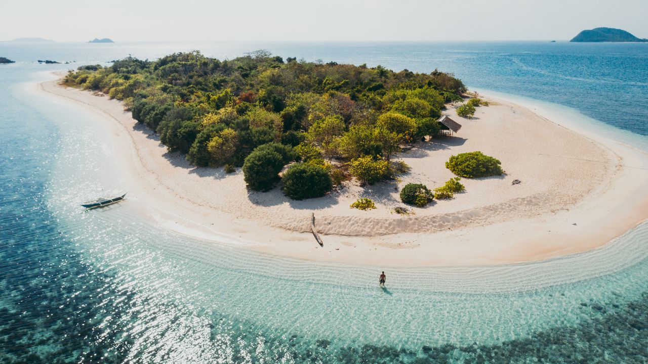 Aerial view of a tropical Philippine island with turquoise water