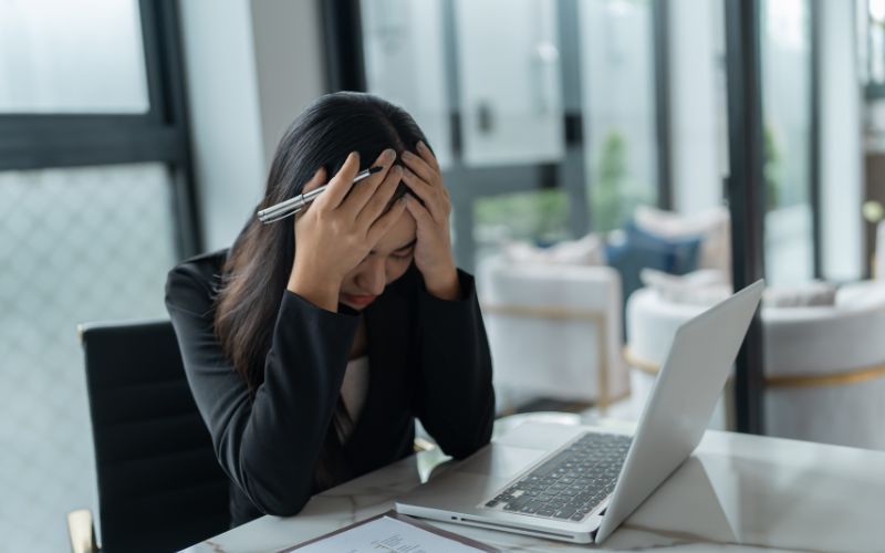 Stressed worker at computer