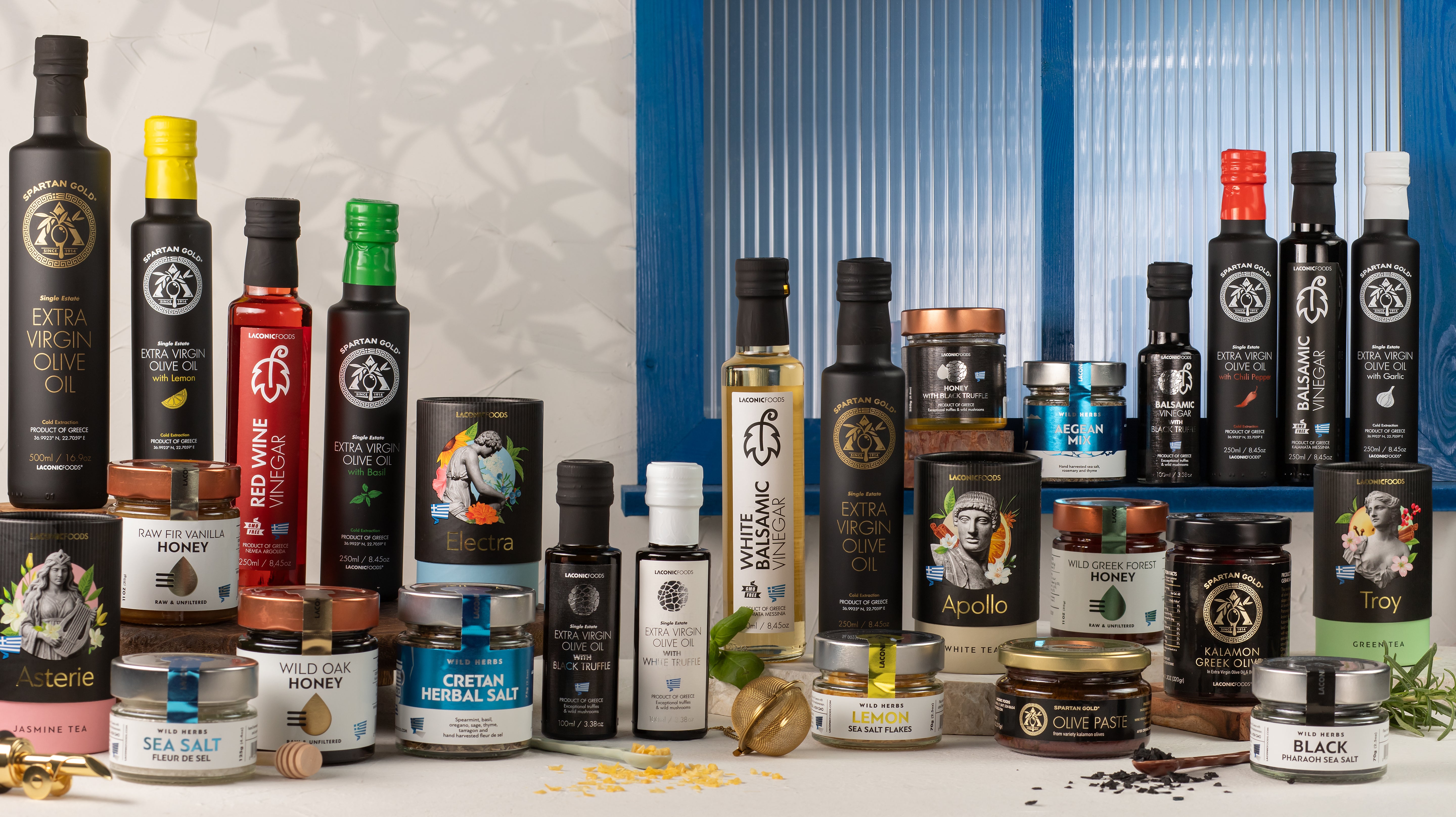 Premium black and green olives in glass jars with olive oil bottle representing Kalina Ltd's imported olive product range