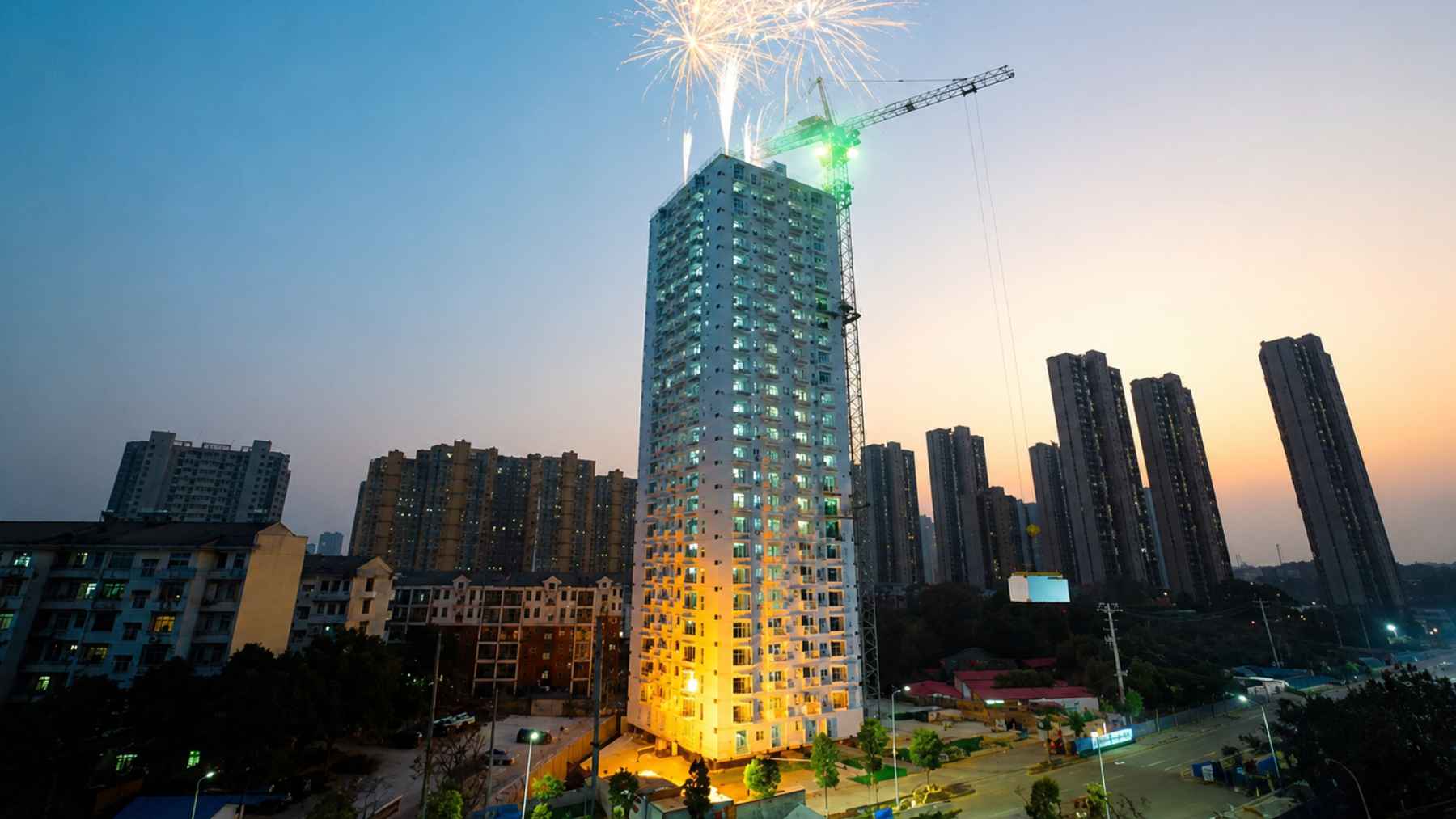 Construction site at night with illuminated cranes