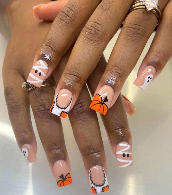 Halloween nails with pumpkin and ghost designs