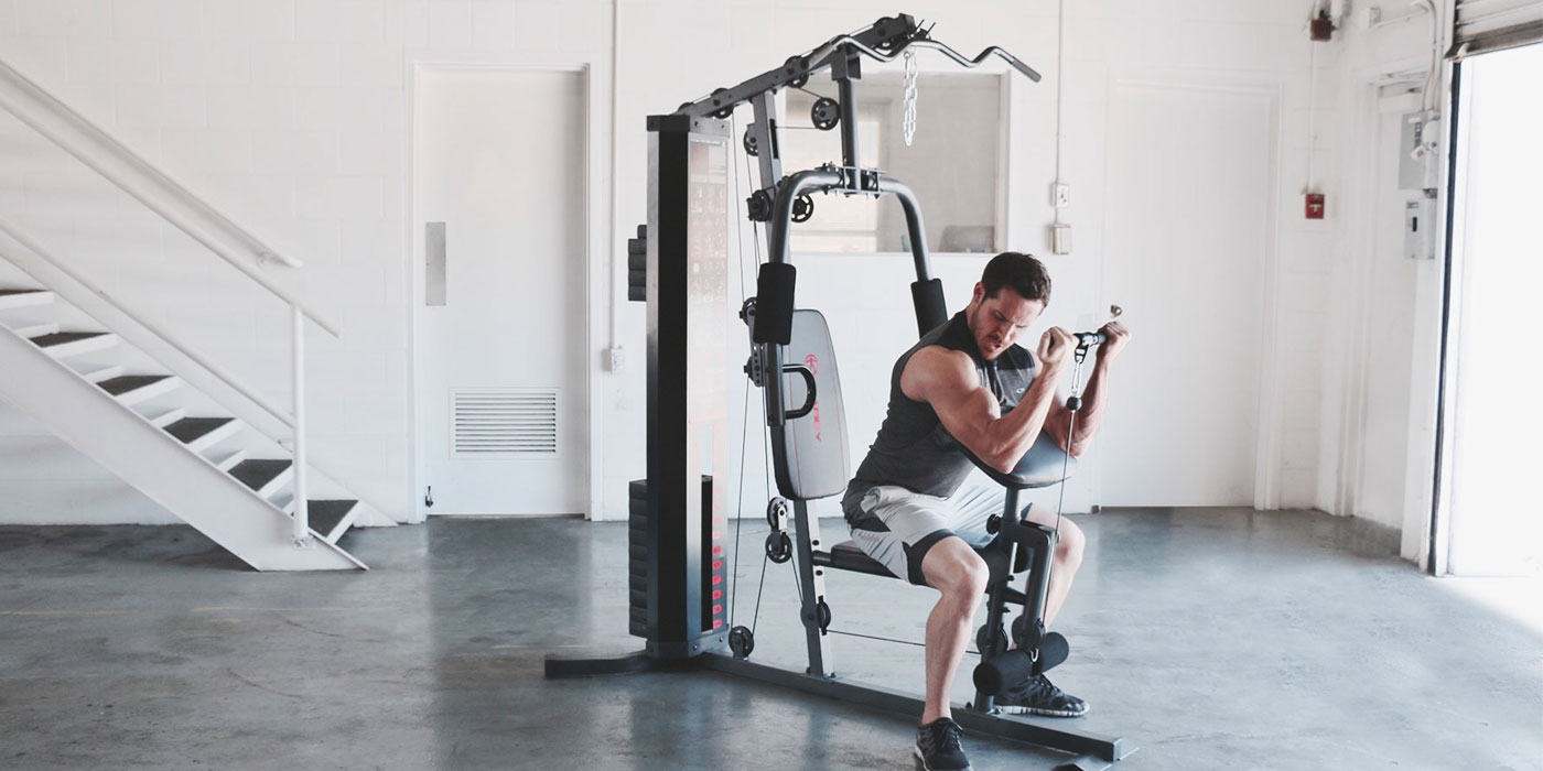 Man using cable machine in gym