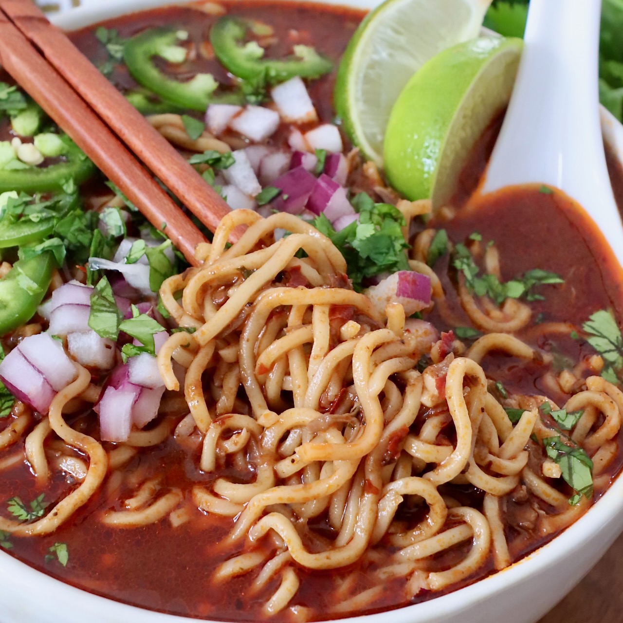 Birria ramen bowl plated with shredded crispy beef, egg, and toppings