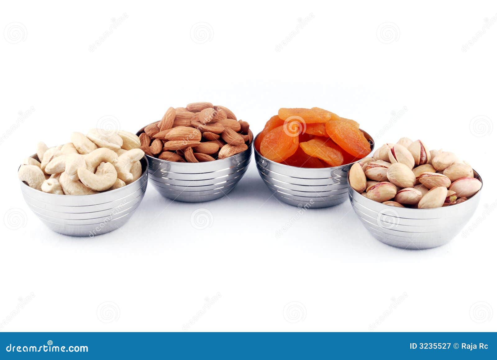 Assorted dried fruits and nuts including almonds cashews pistachios walnuts pumpkin seeds and dried cranberries