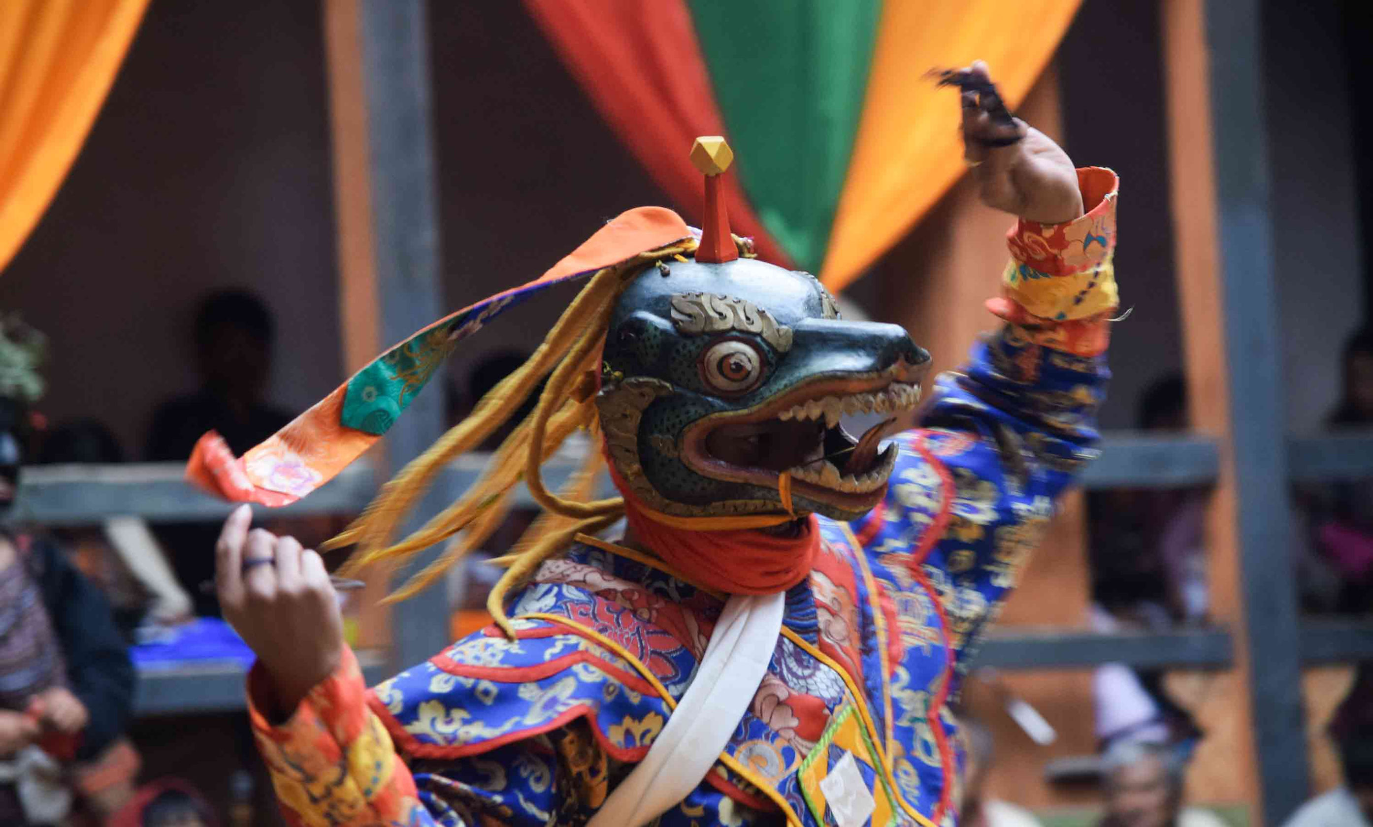 Masked cham dancer performing at a Tshechu festival in Bhutan