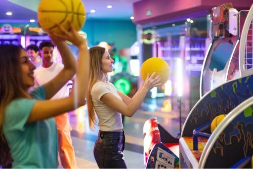 Teens playing arcade games