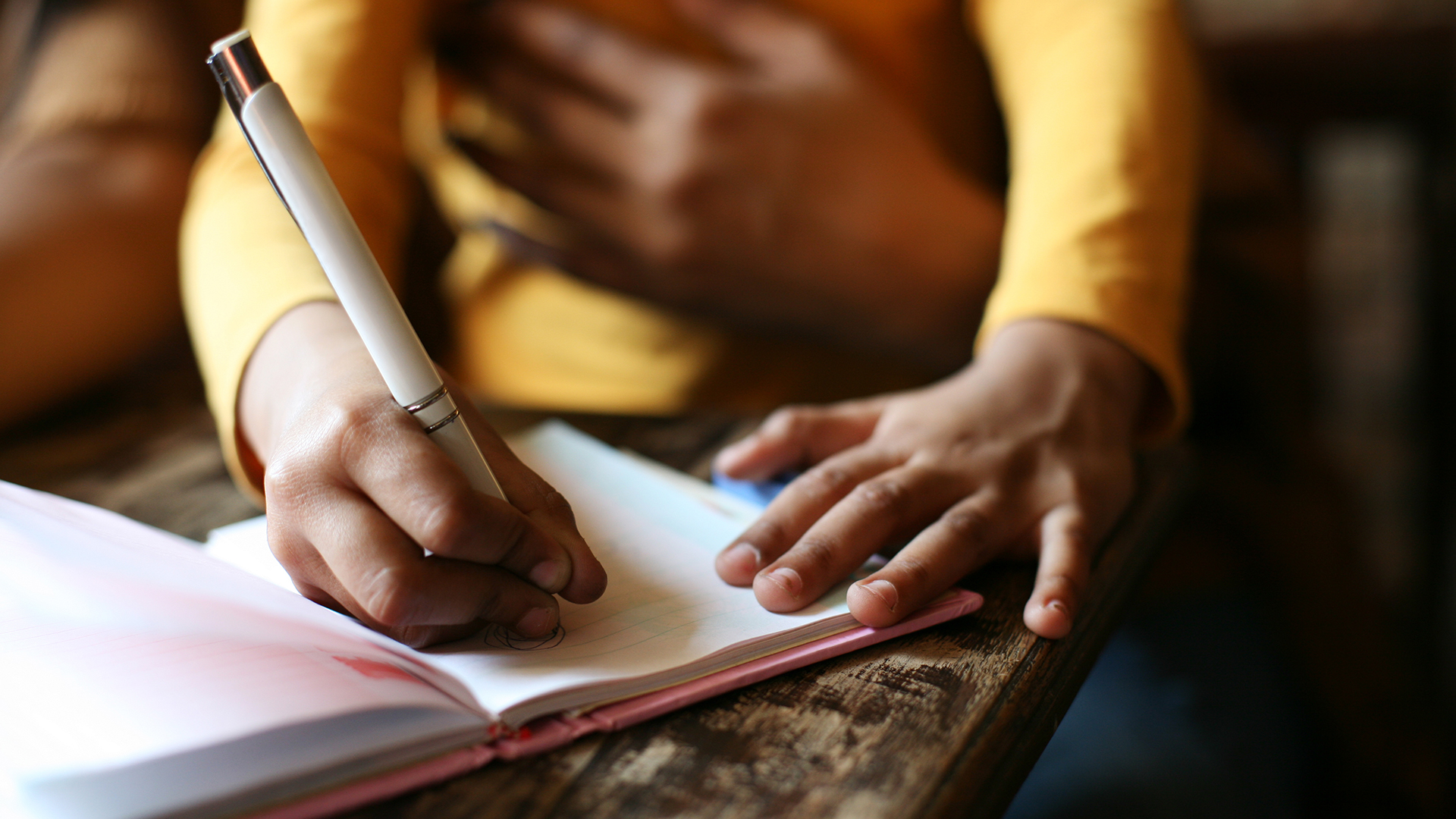 Person writing in notebook