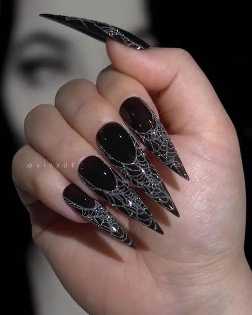 Black sharp nails with silver spider web patterns