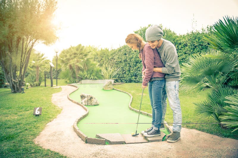 Teens playing mini golf