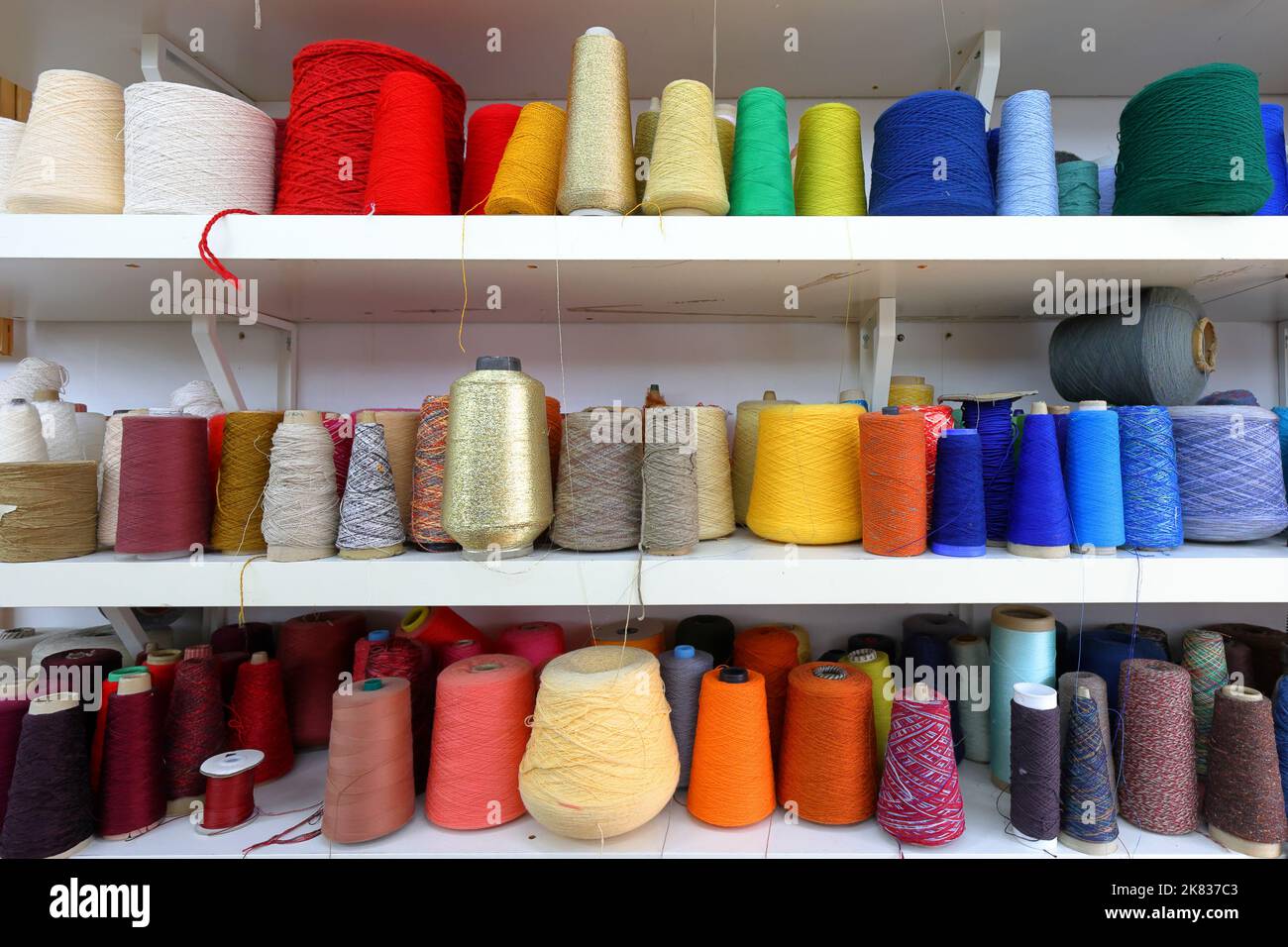 Indonesia Cotton Yarn Importers,Buyers and Purchasers in TurkExim B2B Cotton yarn spools and cones arranged in a textile factory warehouse ready for distribution