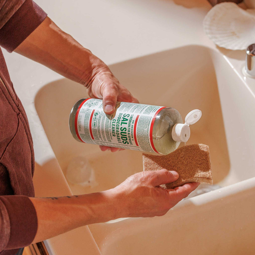 Maundy Clean technician wiping down a kitchen countertop with eco-friendly spray during a spring clean