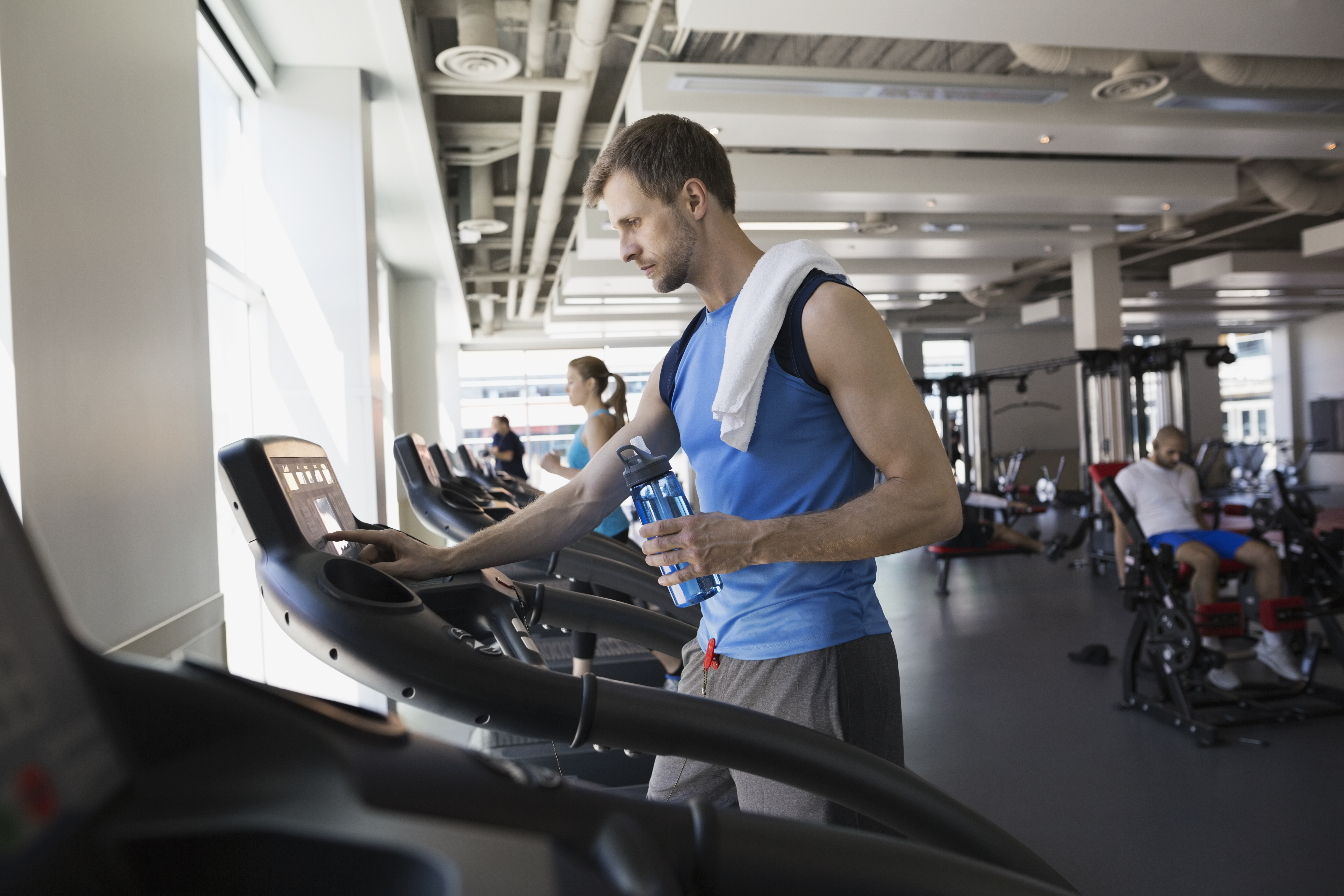 Man using treadmill in gym