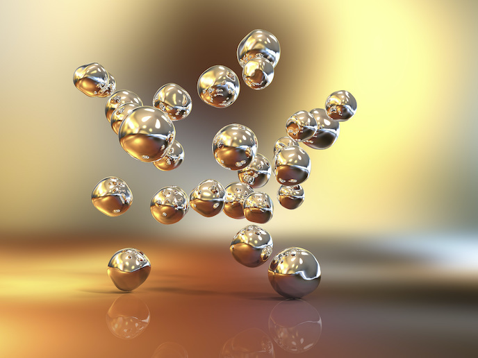 Nanopartículas de oro flotando en un fondo dorado