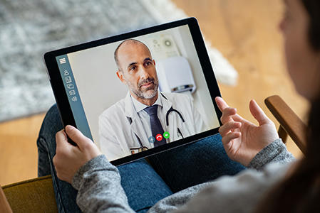 Doctor using tablet for telehealth consultation